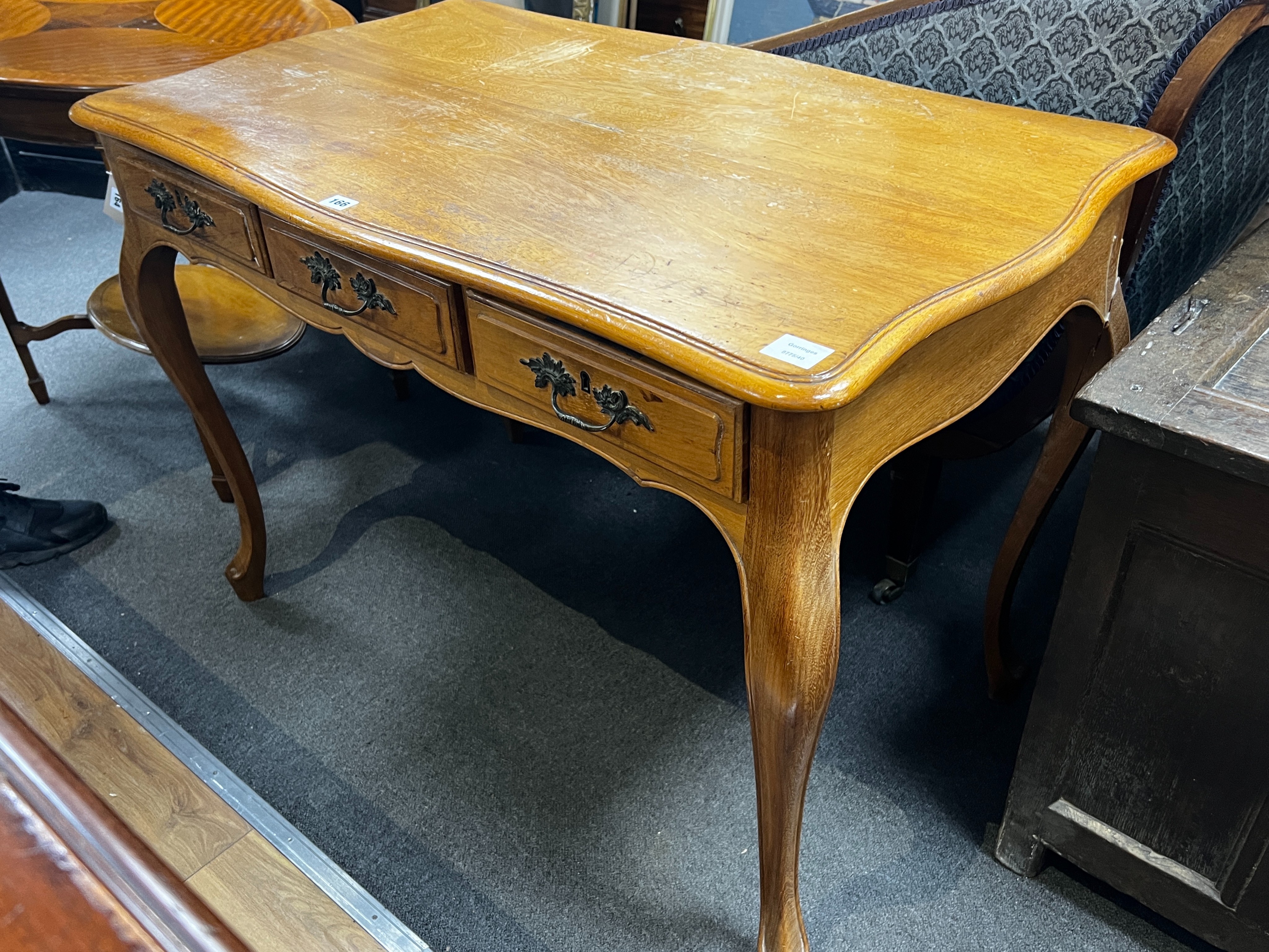 An early 20th century French serpentine three drawer side table, width 108cm, depth 62cm, height 76cm